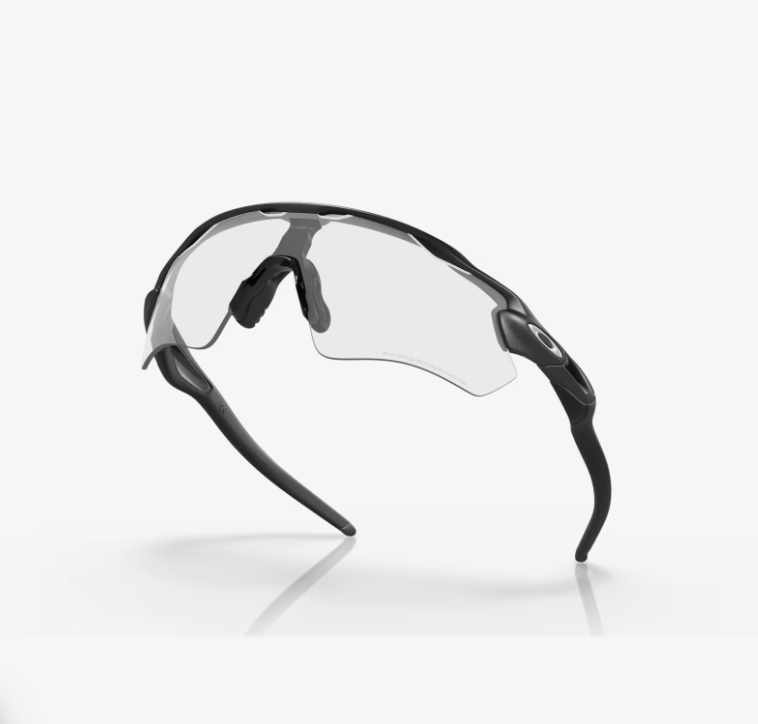 Image Alt Text: Oakley Radar EV Path Steel Clear to Black Iridium Photochromic cycling sunglasses Image Title: Oakley Radar EV Path Steel Photochromic Black Image Caption: Oakley Radar EV Path Steel cycling sunglasses with Clear to Black Iridium Photochromic lenses. Image Description: Oakley Radar EV Path Steel Photochromic cycling sunglasses featuring a Steel O Matter™️ frame and Clear to Black Iridium Photochromic lens. The sunglasses feature HDO®️ optics, Unobtainium®️ earsocks and nosepads, a performance shield lens and Regular High Bridge Fit, making them suitable for cycling and active outdoor use in changing light conditions.